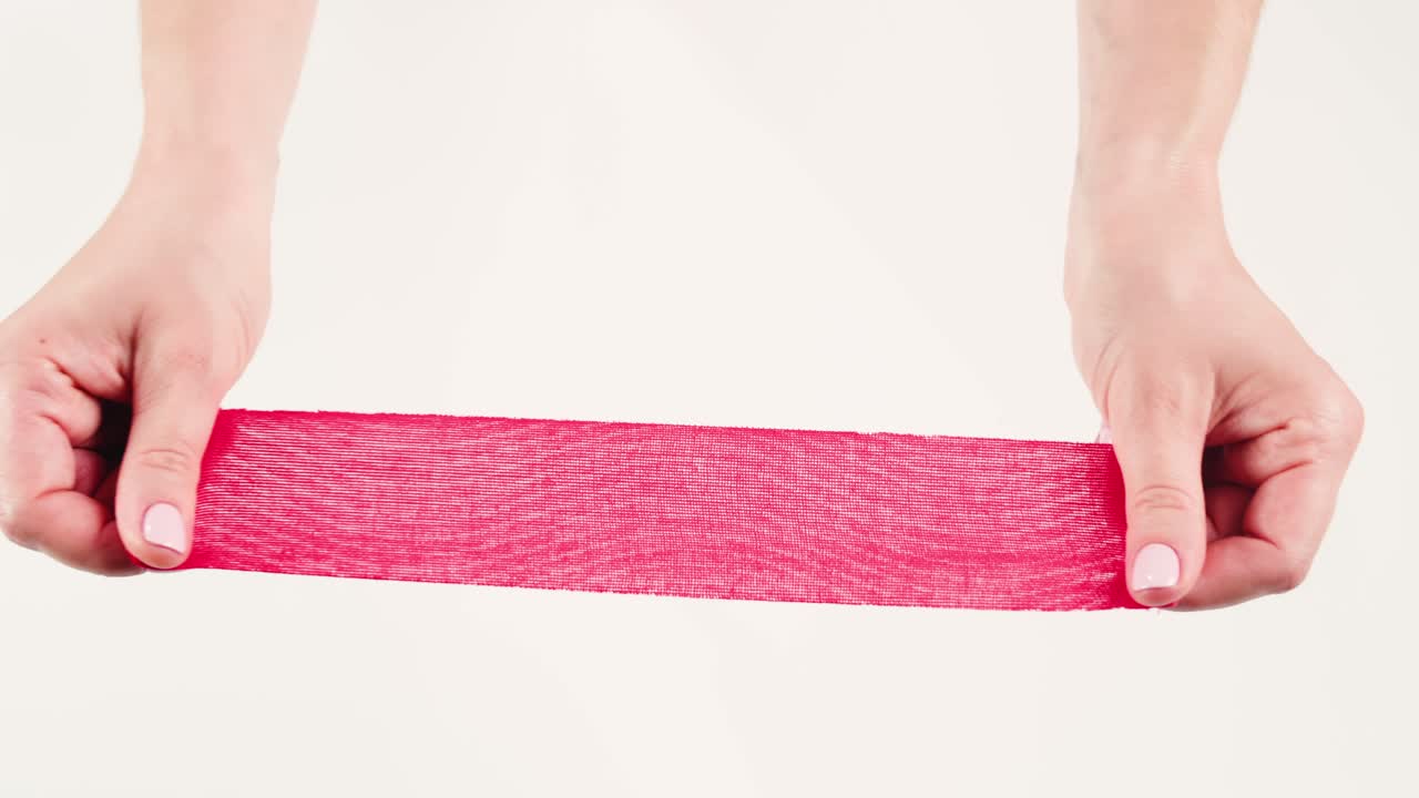 Kinesiology medical taping, doctor Physical therapist applying elastic surgical tape to patient body, treating injured knee young athlete.Post traumatic rehabilitation, sport physical therapy recovery