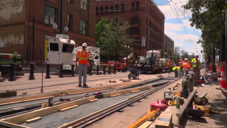 time lapse video of construction workers laying new railroad tracks in a city.