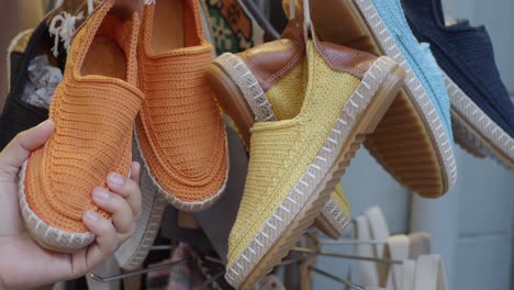 colorful knitted espadrilles hanging in a shop