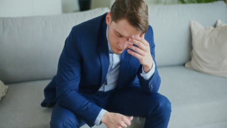 devastated businessman on sofa