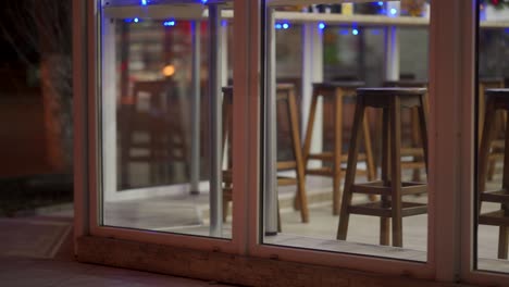 coffee shop window display with festive lighting at dusk, cafe in the evening