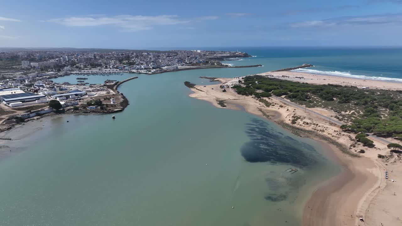 Cinematic shot of the Loukkos River estuary in Larache, near the ancient site of Lixus, highlighting the calm waters, coastline, and natural landscape