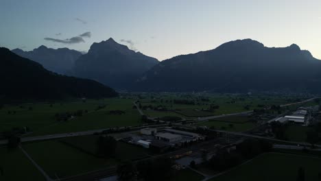 Aerial-clip-of-the-lake-in-the-valley-around-the-high-mountain-peaks-with-a-fountain-and-lots-of-water-sports