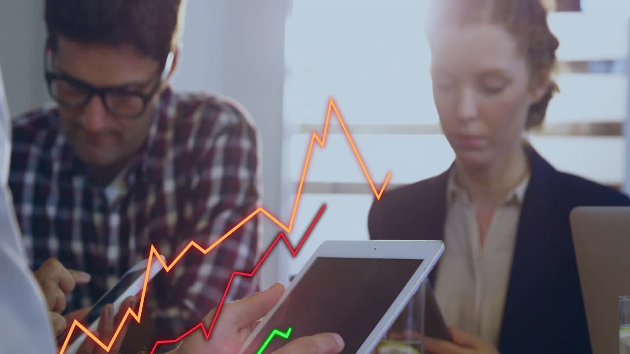 Woman holding tablet and man scrolling smartphone in business office displaying bright rising graph