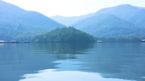 calm water reflects a tranquil mountainous landscape