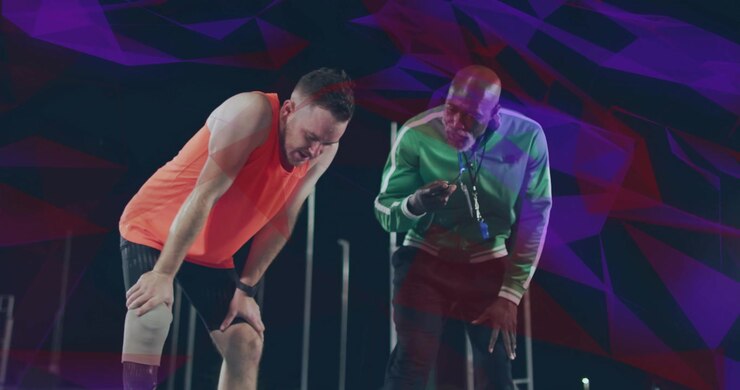 Atleta con protesi che si ferma in pista mentre l'allenatore controlla il cronometro, preparando un esercizio sportivo
