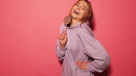 woman with lollipop in purple hoodie