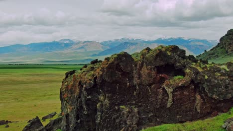 Black-Rocky-Green-Hills-with-Bird-Flyby-Aerial-Drone-Footage-Fast-on-Cloudy-Day-revealing-majestic-mountains-in-the-distance-near-Interstate-15-in-Central-Utah-USA