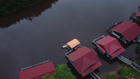 drone tilt view of red guest houses in rompin pahang river, malaysia