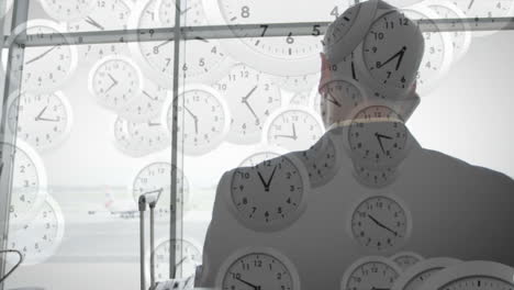 animation of clocks moving over caucasian businessman talking on phone