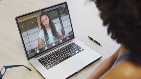 African-american-businesswoman-using-laptop-for-video-call-with-biracial-business-colleague