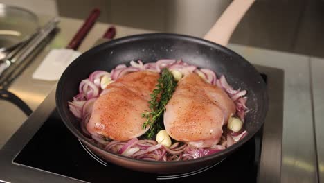 chicken breast cooking in a pan