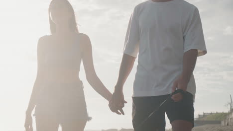 guy and girl holding hands walking