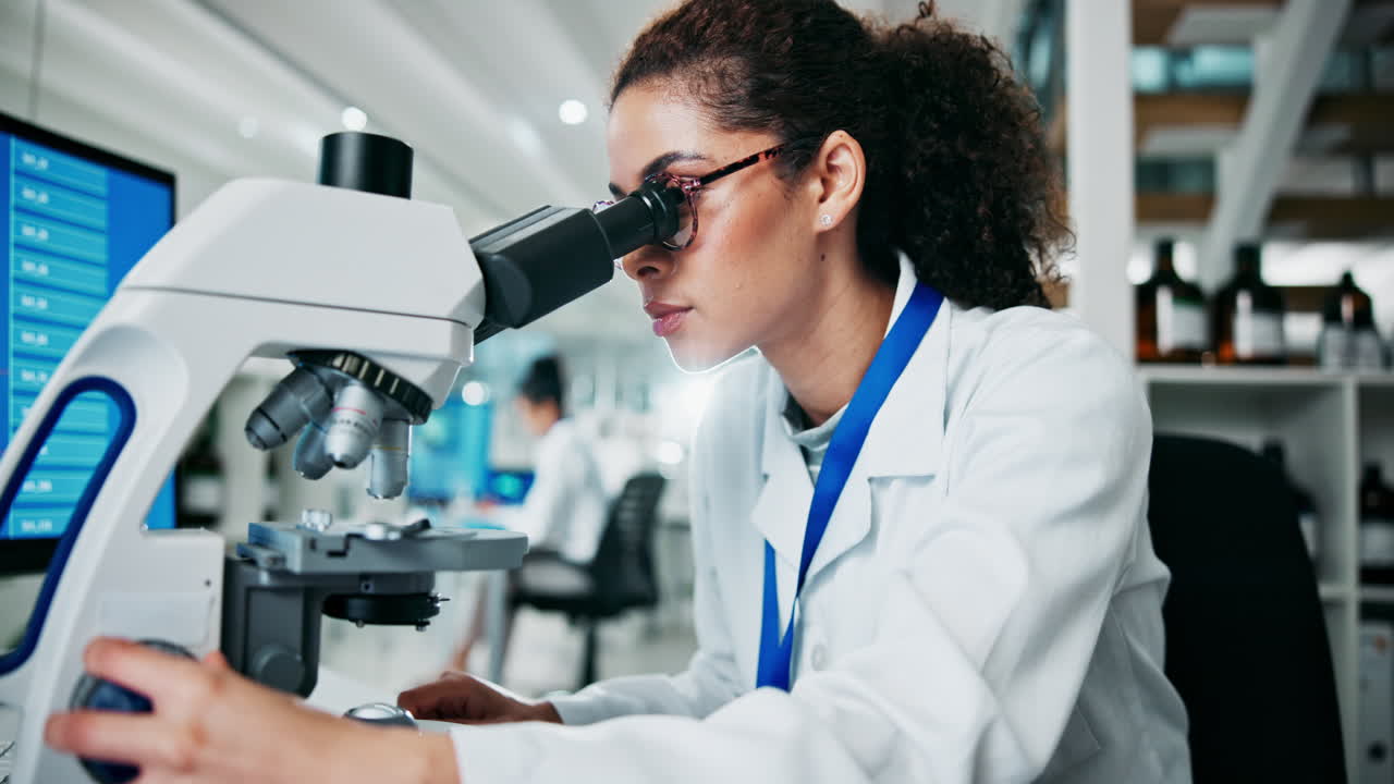 Scientist working with a microscope in a laboratory