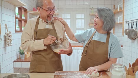 happy senior couple baking together