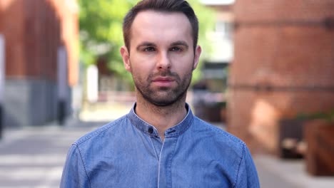 portrait of serious casual man looking at camera