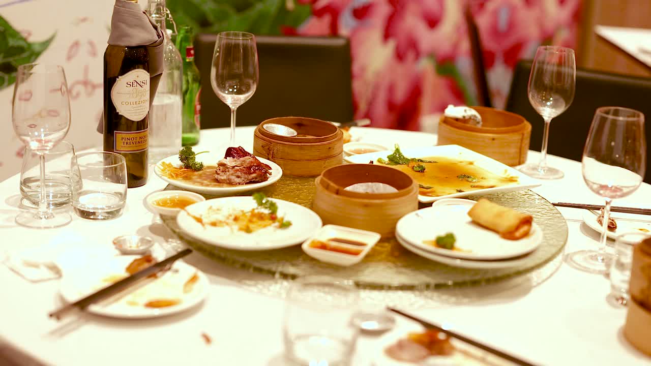 A beautifully set dining table with Chinese cuisine, showcasing a warm and inviting atmosphere with dim lighting