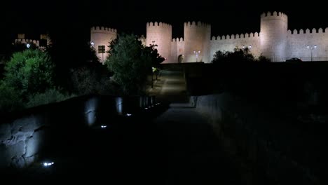 avila under the night sky, with the old town and its unesco world heritage medieval walls bathed in light.