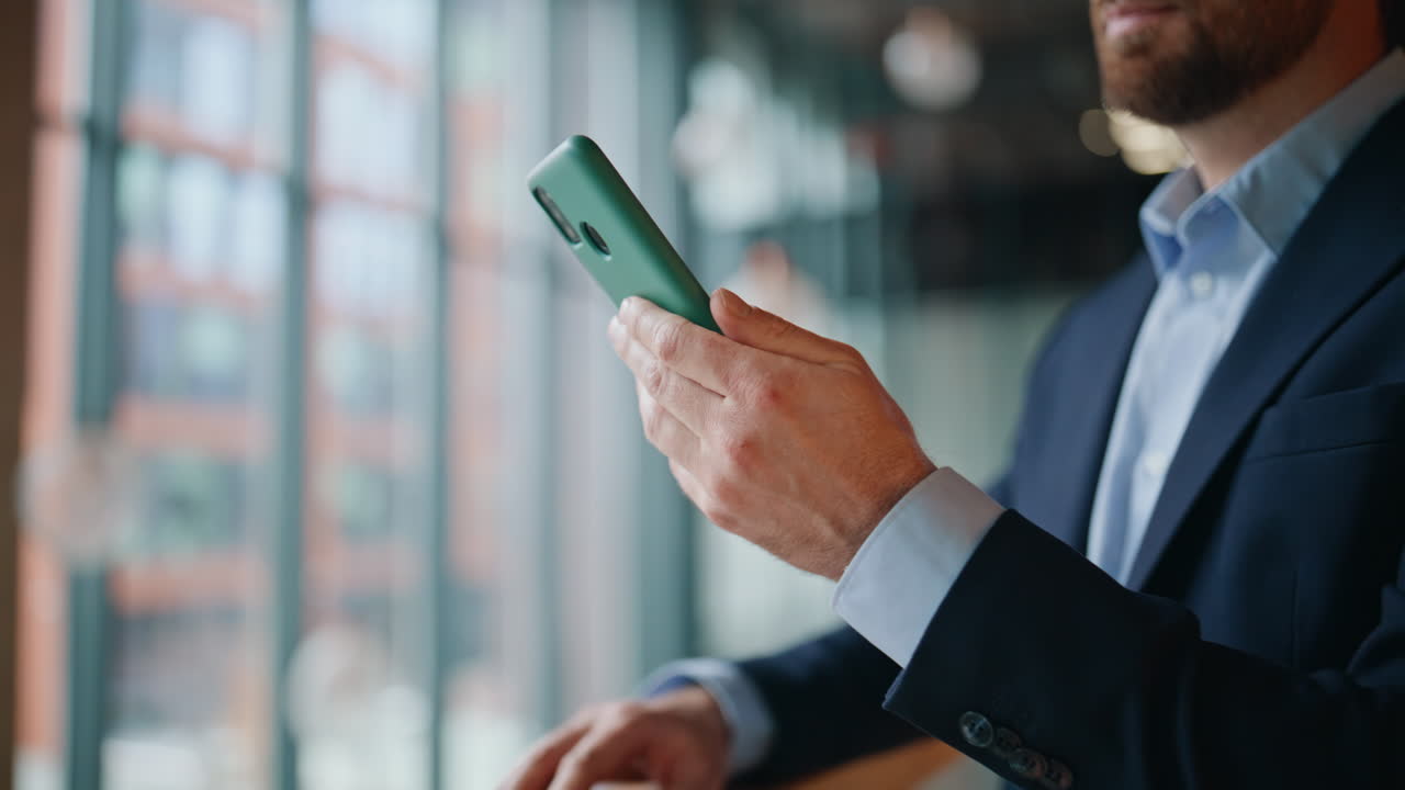 Smiling boss tapping cellphone making online order standing office lobby closeup