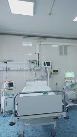 modern ward of intensive care unit. hospital room with bed and medical equipment in clinic. interior of emergency room. reanimation room. vertical video