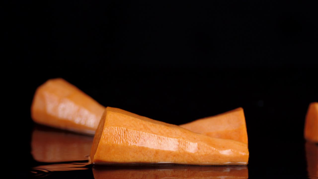 A fall of fresh carrot in the water splash.