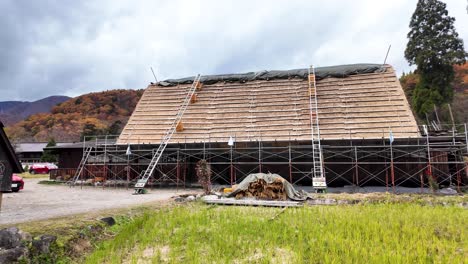 scaffolding set up for the restoration of a gasshō-zukuri roof in shirakawa-go. pan right shot