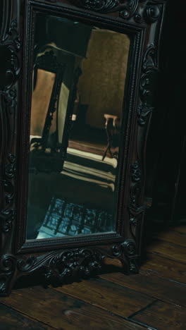 antique carved mirror in a dark room
