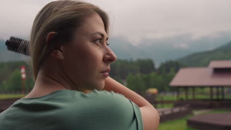 thoughtful woman tourist brushes blonde hair in eco hotel