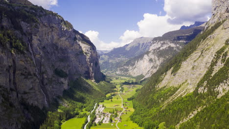 aerial hyperlapse over green valley between beautiful mountains