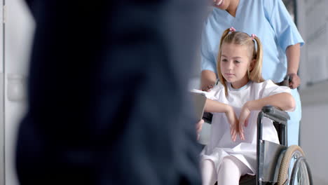 doctor discussing with a young caucasian girl in a hospital, with copy space