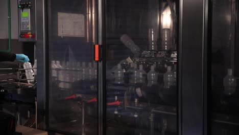 Plastic-Bottles-Inside-a-Glass-Cabinet-at-a-Factory-Being-Cleaned-and-Sterilised-for-Vinegar