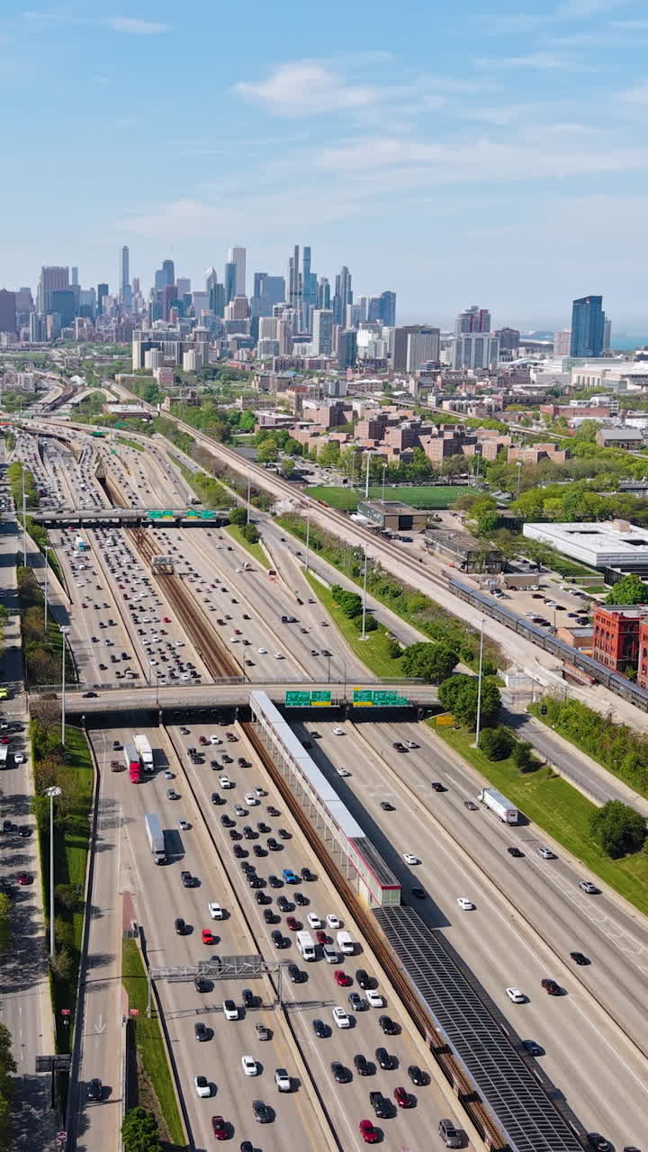 Vertical Drone Shot of I-90 Highway Traffic in South Chicago USA, Expressway, Railway and Downtown in Misty Skyline