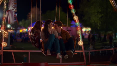 couple on a swing ride at a night carnival