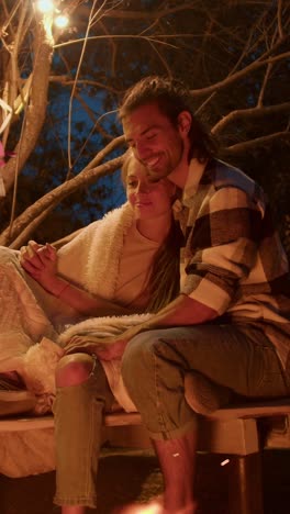 couple enjoying a campfire at night