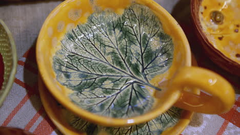 handmade ceramic cup and saucer with leaf design