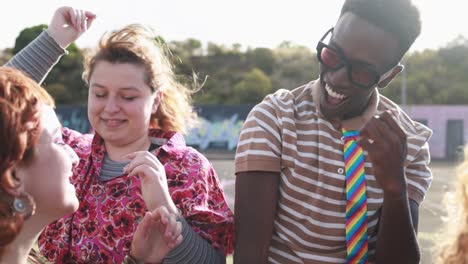 happy young people dancing outdoor at festival event - party and entertainment concept