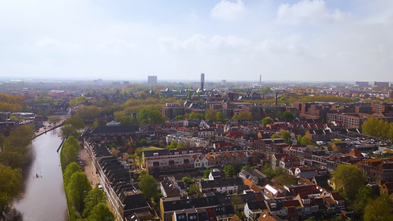 Impressive drone shot over the old center of Delft, highlighting the iconic Nieuwe Kerk and surrounding historic architecture. A perfect view of the Dutch skyline in clear daylight.