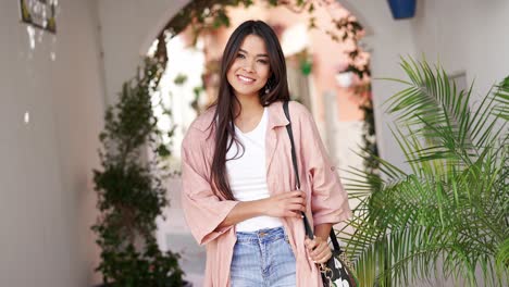 young woman smiling in a city street