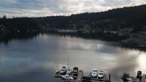 Aerial-drone-shot-of-boats-docked-in-a-lake-in-northern-Vancouver,-British-Columbia