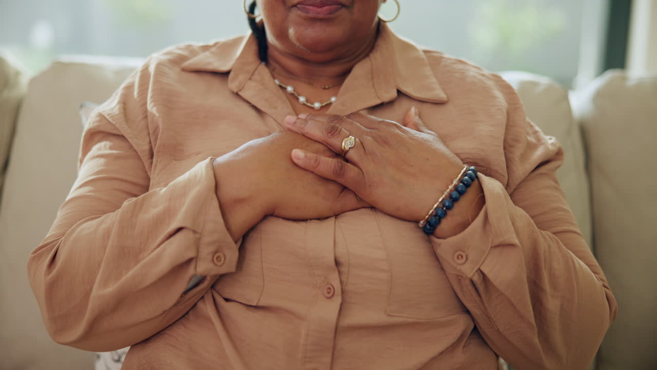 Close-up of Woman's Hands Over Heart Expressing Gratitude