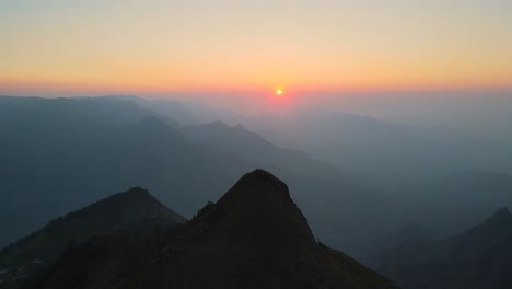 aerial drone shot of kolukkumalai range in the morning, revealing its majestic peaks