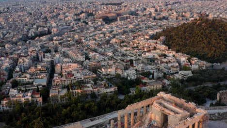 aerial view of buildings in athens city with historic parthenon temple at acropolis of athens in greece