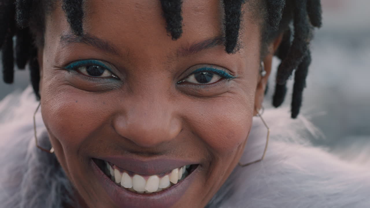 close up portrait beautiful african american woman on rooftop laughing happy enjoying urban lifestyle wearing stylish fashion