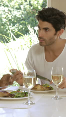 young couple talking while having meal