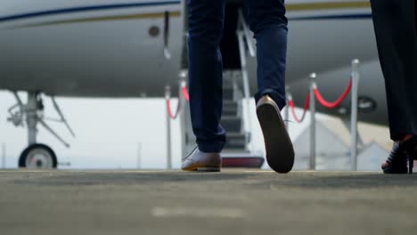 business people walking towards private jet 4k