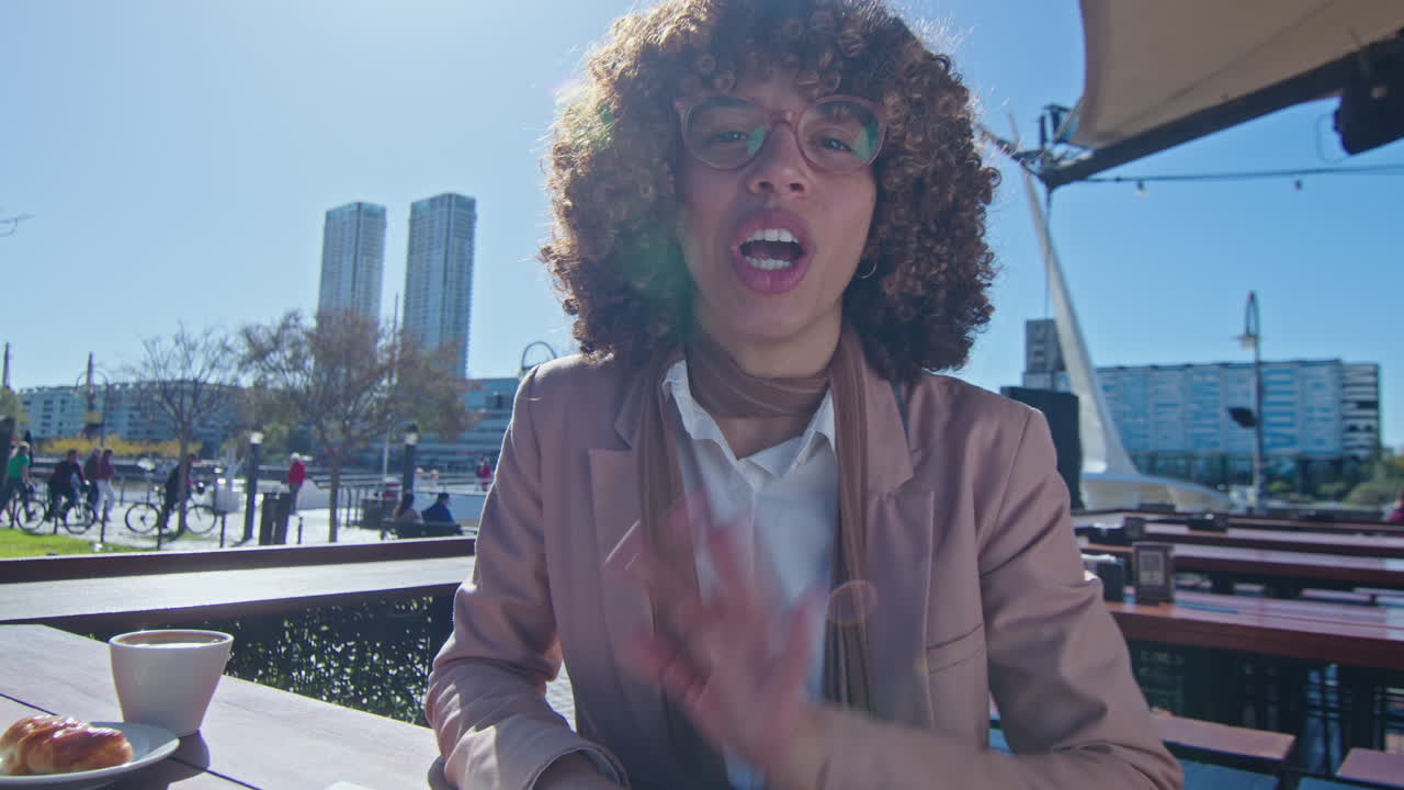 POV Young Black Businesswoman Talking on Video Call in Outdoor Cafe