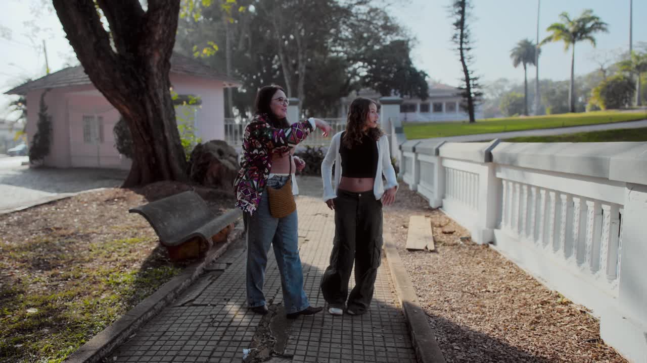 Two friends strolling and conversing outdoors