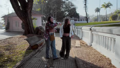 two friends strolling and conversing outdoors