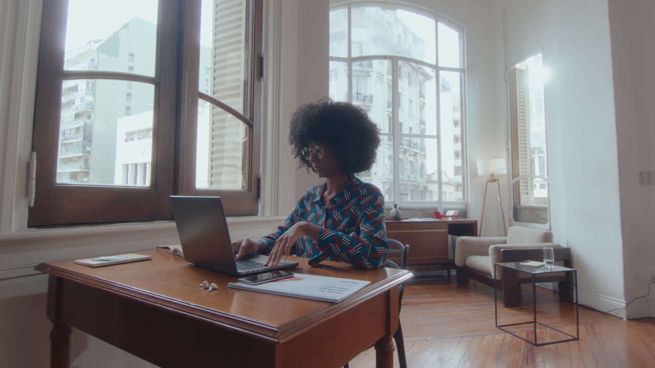 Young Black Businesswoman Web Conferencing on Laptop in the Office