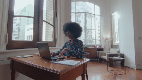 young black businesswoman web conferencing on laptop in the office